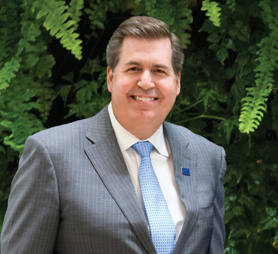A professor and student look at a computer screen in a laboratory